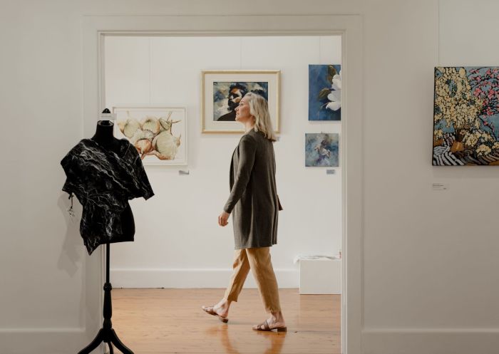 A woman visiting white art gallery at Shearing the Rams Trail, Corowa, The Murray, Country NSW